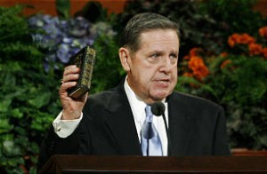 Elder Holland holds the Book of Mormon belonging to Hyrum Smith